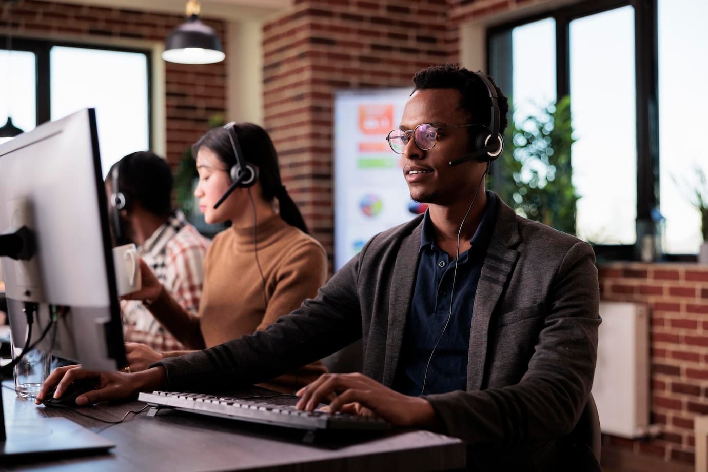 ABOUT 1 african american helpline employee working call center reception with multiple monitors male operator using telecommunication help clients customer service support remote network 482257 44585